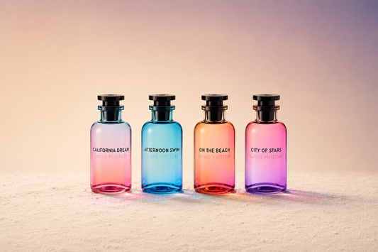 Four Louis Vuitton perfume bottles in a row on sand